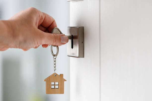 Keys in an lock with a new house keyring attached.